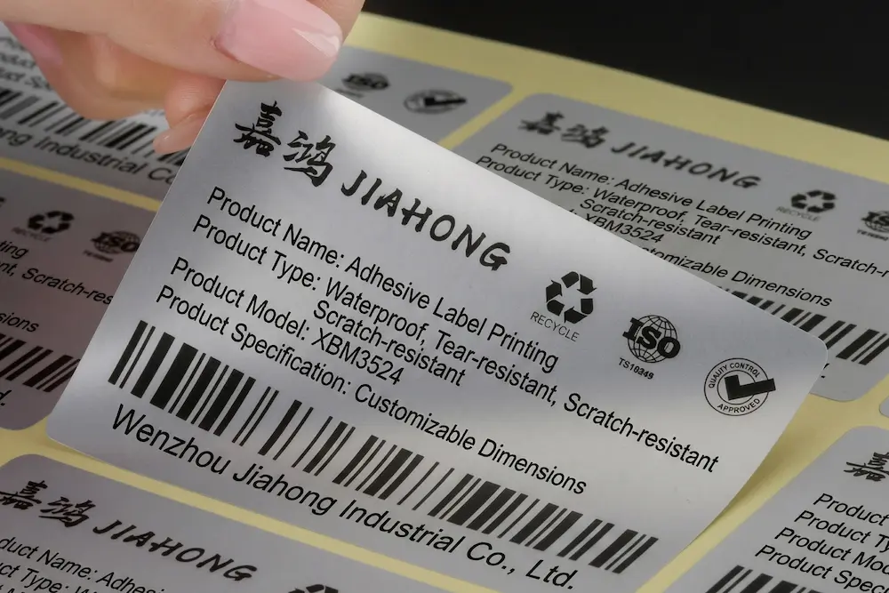 Custom printed matte silver PET self-adhesive labels for industrial and electronic equipment.