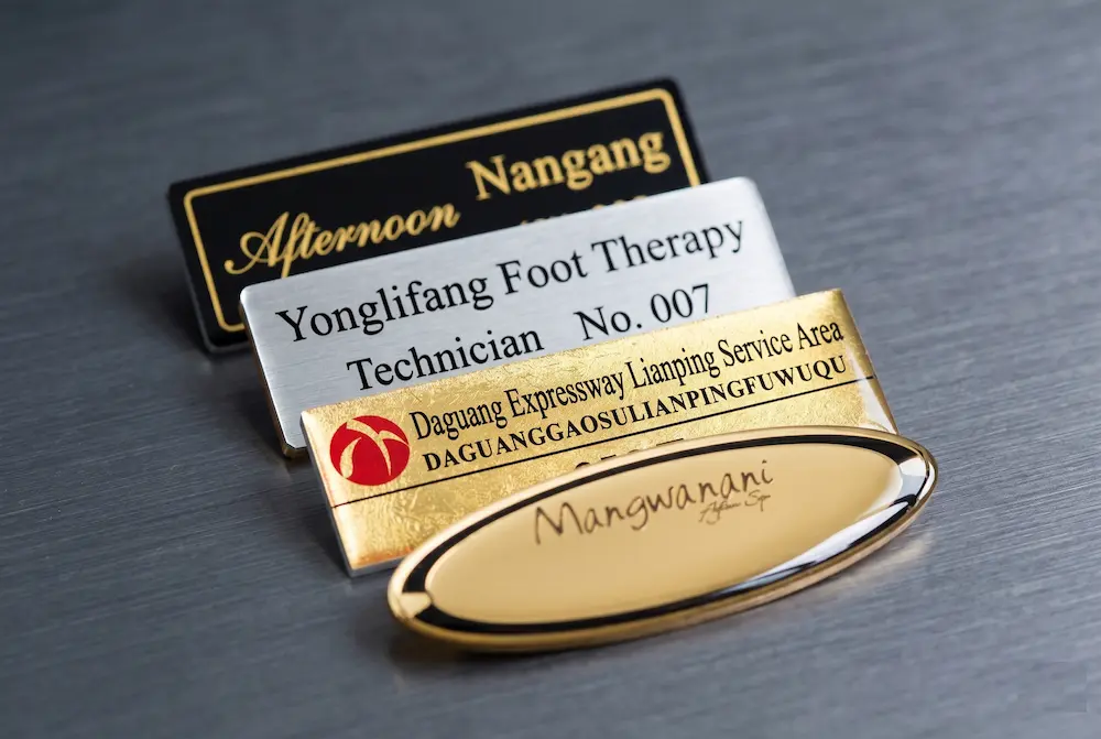 Custom domed acrylic name badges with 3D scratch-resistant resin finish for corporate staff